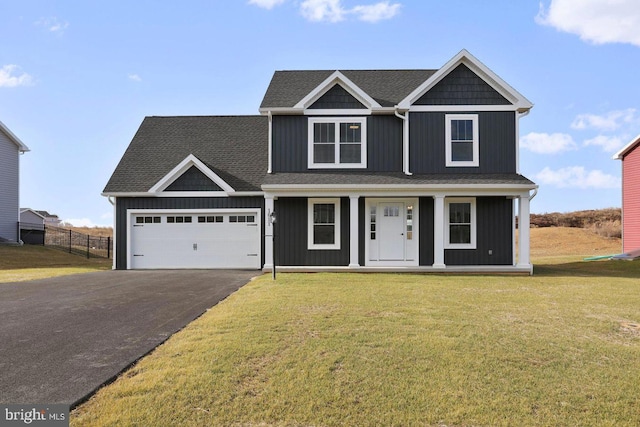 1011 Southwood Dr, Shippensburg, PA 17257 - view of front facade with asphalt driveway, a garage, a porch, board and batten siding, and roof with shingles