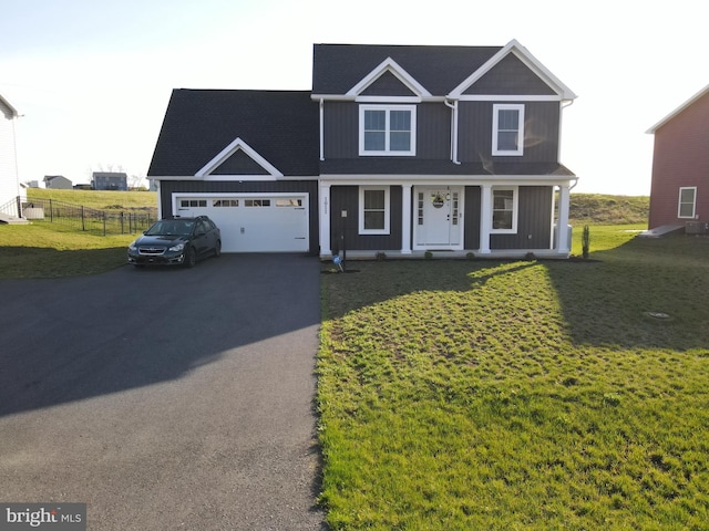 1011 Southwood Dr, Shippensburg, PA 17257 - view of front of home with driveway, a garage, a porch, and board and batten siding