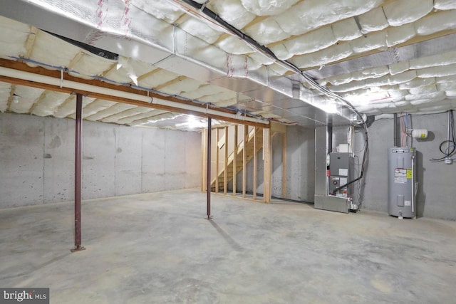 1011 Southwood Dr, Shippensburg, PA 17257 - unfinished below grade area featuring electric water heater, stairway, and heating unit