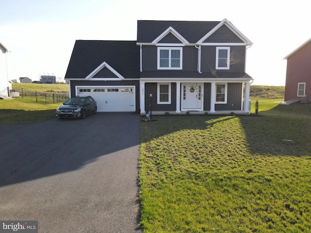 1011 Southwood Dr, Shippensburg, PA 17257 - view of front of home featuring driveway, a garage, a porch, and board and batten siding