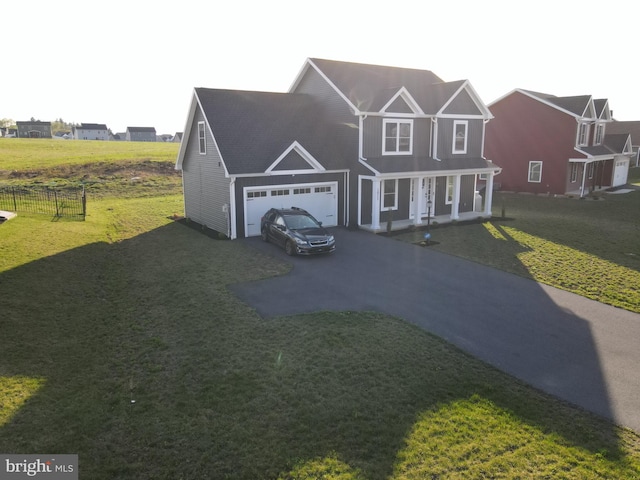 1011 Southwood Dr, Shippensburg, PA 17257 - view of front of home featuring covered porch, driveway, a front lawn, and a garage