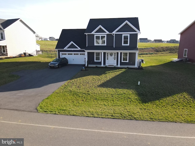 1011 Southwood Dr, Shippensburg, PA 17257 - traditional home with asphalt driveway, a porch, and a front yard