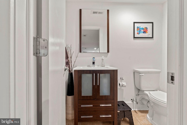 bathroom featuring toilet, tile patterned floors, visible vents, and vanity
