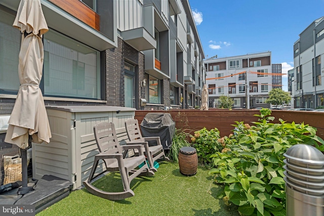 view of patio featuring area for grilling and fence