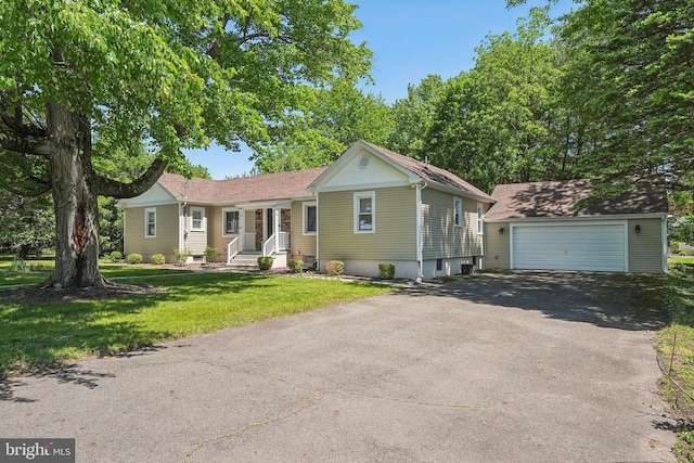 562 Washington Ave, Ewing, NJ 08628 - ranch-style home featuring an outdoor structure, a detached garage, and a front lawn