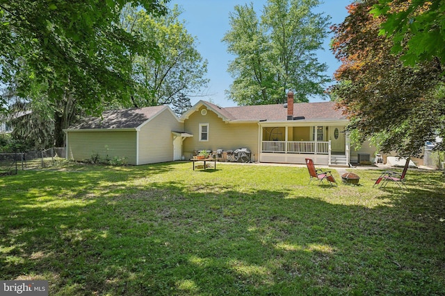 562 Washington Ave, Ewing, NJ 08628 - back of property featuring a fire pit, an outbuilding, and a chimney