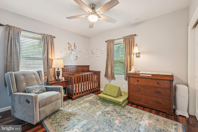 562 Washington Ave, Ewing, NJ 08628 - bedroom with wood finished floors, multiple windows, and a nursery area