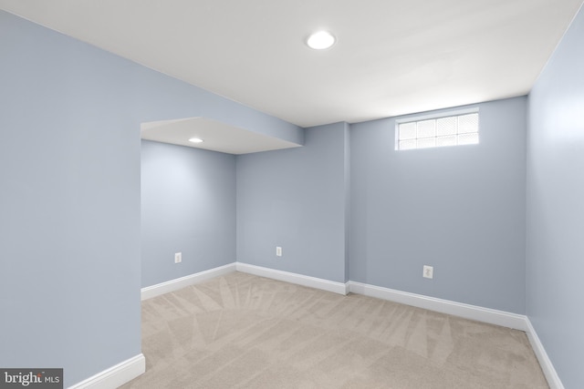 below grade area with carpet floors, recessed lighting, and baseboards