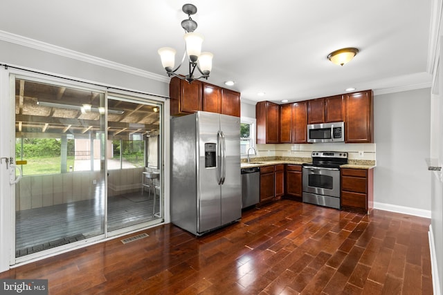kitchen with visible vents, crown molding, appliances with stainless steel finishes, light stone countertops, and baseboards