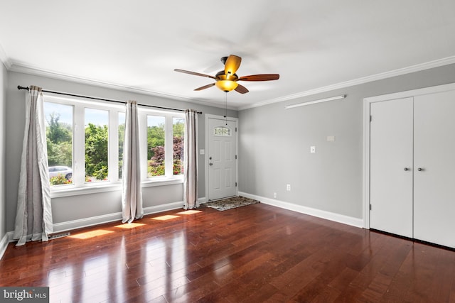 interior space featuring baseboards, ceiling fan, ornamental molding, and hardwood / wood-style flooring