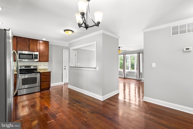 kitchen featuring baseboards, appliances with stainless steel finishes, ornamental molding, and visible vents