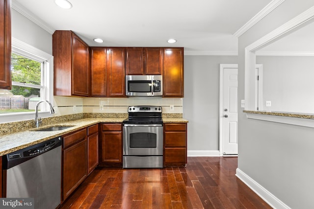 kitchen with a sink, light stone countertops, stainless steel appliances, and dark wood-style floors