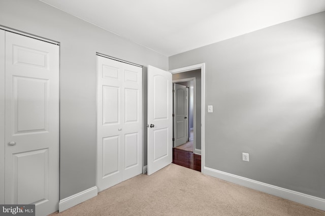 unfurnished bedroom featuring baseboards and carpet