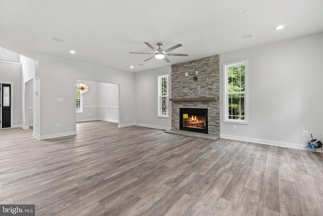14875 Buckingham Ct, Issue, MD 20645 - unfurnished living room with wood finished floors, ceiling fan, a fireplace, baseboards, and recessed lighting