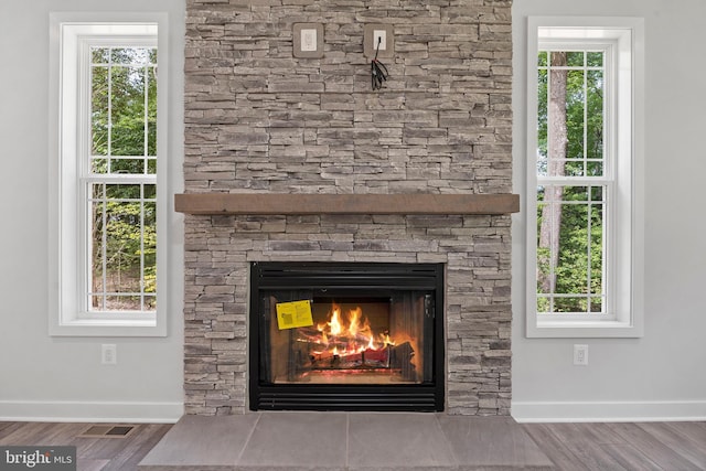 14875 Buckingham Ct, Issue, MD 20645 - detailed view of baseboards, a fireplace, and wood finished floors