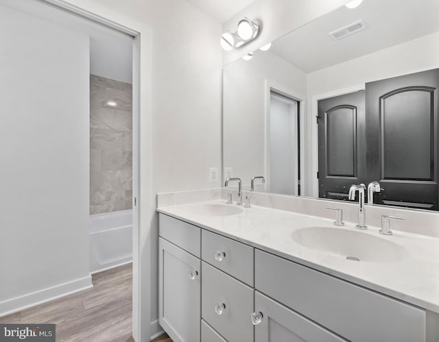 14875 Buckingham Ct, Issue, MD 20645 - full bath with wood finished floors, double vanity, and baseboards
