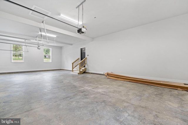 14875 Buckingham Ct, Issue, MD 20645 - garage featuring a garage door opener and baseboards
