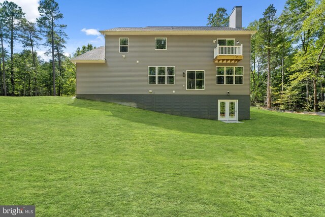 14875 Buckingham Ct, Issue, MD 20645 - rear view of property featuring french doors, a lawn, a chimney, and a balcony