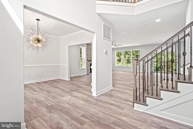 14875 Buckingham Ct, Issue, MD 20645 - foyer entrance with baseboards, a chandelier, stairs, wood finished floors, and ornamental molding