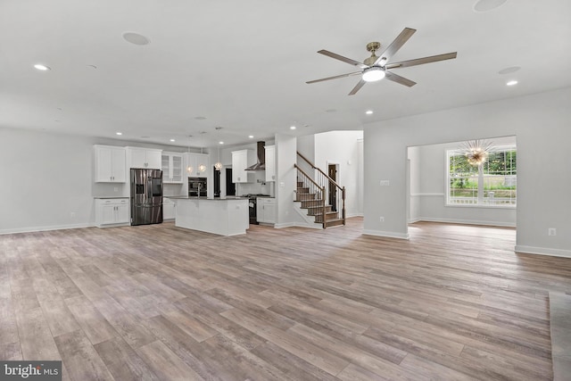 14875 Buckingham Ct, Issue, MD 20645 - unfurnished living room featuring light wood-style floors, a ceiling fan, stairs, recessed lighting, and baseboards