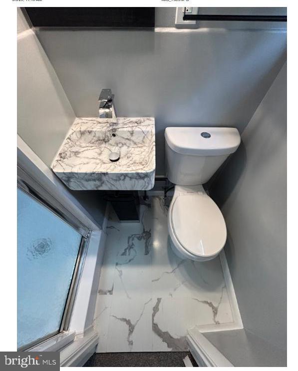 7204 Croydon Rd, Baltimore, MD 21207 - bathroom featuring marble look tile flooring and toilet