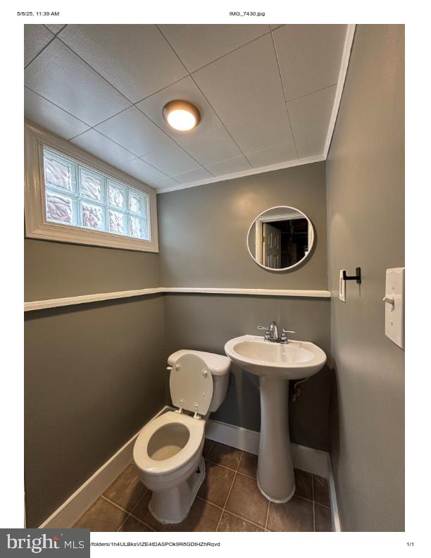 7204 Croydon Rd, Baltimore, MD 21207 - half bathroom featuring baseboards, tile patterned flooring, and toilet