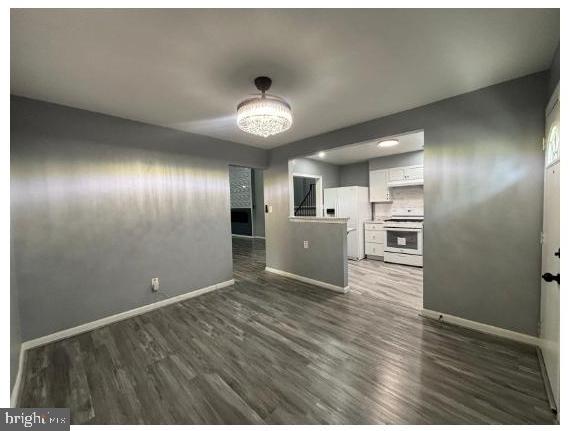 7204 Croydon Rd, Baltimore, MD 21207 - unfurnished room with baseboards and dark wood-type flooring