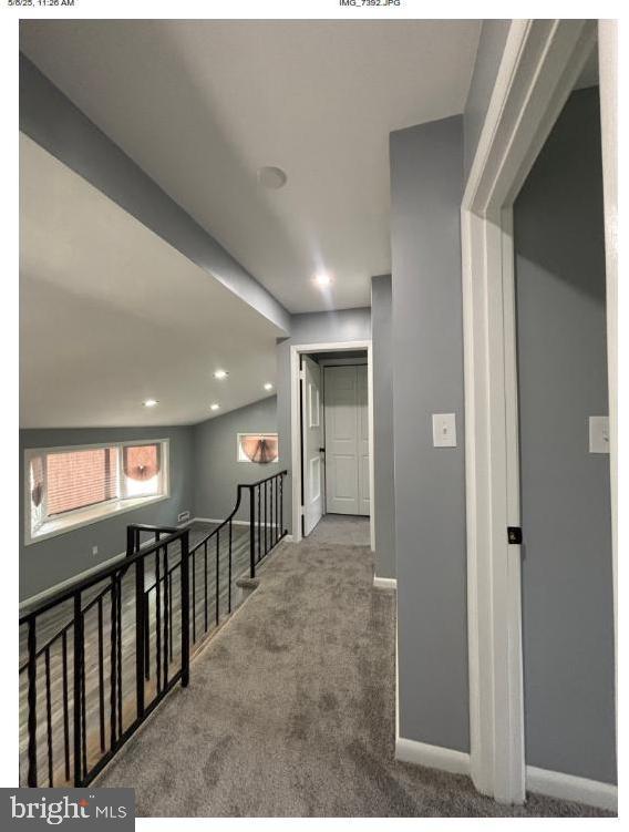 7204 Croydon Rd, Baltimore, MD 21207 - hall with an upstairs landing, carpet, and baseboards