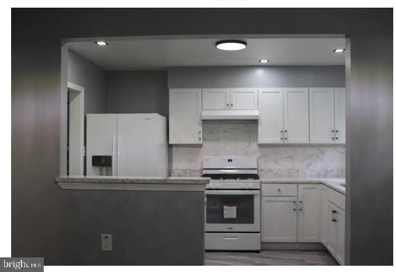7204 Croydon Rd, Baltimore, MD 21207 - kitchen with gas stove, white fridge with ice dispenser, light countertops, decorative backsplash, and recessed lighting