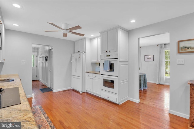 107 Forest Ave, Medford, NJ 08055 - kitchen featuring a ceiling fan, light stone countertops, baseboards, white appliances, and light wood-style floors