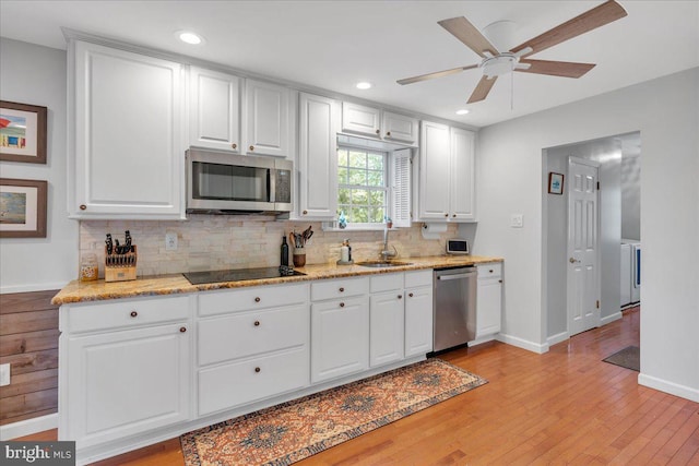 107 Forest Ave, Medford, NJ 08055 - kitchen with a sink, white cabinets, stainless steel appliances, tasteful backsplash, and light wood-type flooring