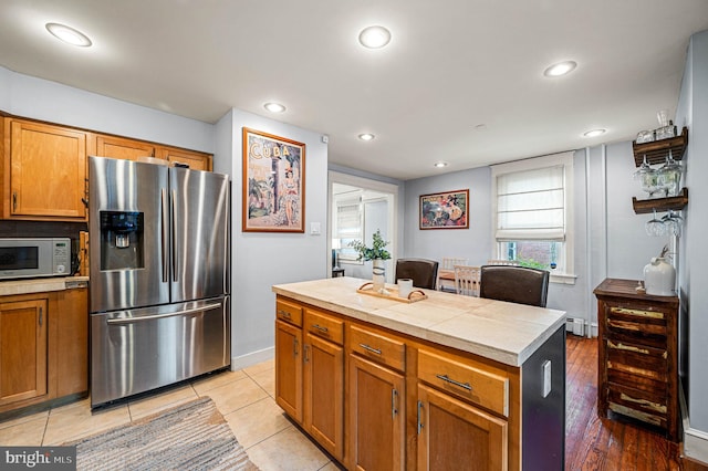 4037 Mitchell St, Philadelphia, PA 19128 - kitchen featuring baseboards, baseboard heating, recessed lighting, brown cabinets, and appliances with stainless steel finishes
