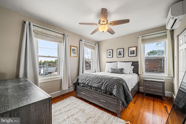 4037 Mitchell St, Philadelphia, PA 19128 - bedroom featuring baseboards, wood-type flooring, a wall mounted AC, and multiple windows