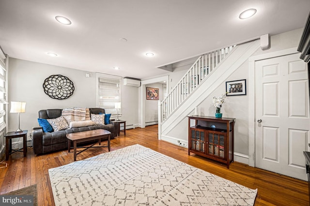 4037 Mitchell St, Philadelphia, PA 19128 - living area featuring an AC wall unit, wood finished floors, baseboard heating, and stairway