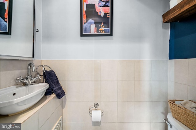 4037 Mitchell St, Philadelphia, PA 19128 - bathroom featuring toilet, tile walls, and a sink