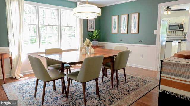 30 Woods Ln, Hanover, PA 17331 - dining room featuring crown molding, wood finished floors, a ceiling fan, and a wainscoted wall