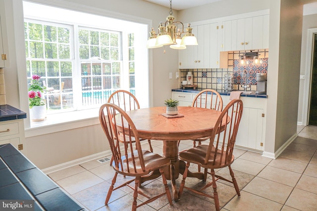 30 Woods Ln, Hanover, PA 17331 - dining area with light tile patterned floors, baseboards, and a chandelier