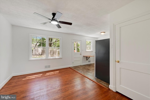 705 Stewart Ave, Glen Burnie, MD 21061 - spare room with a textured ceiling, wood finished floors, a ceiling fan, and baseboards