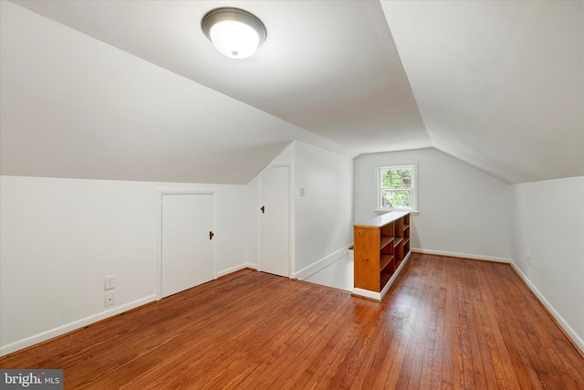 705 Stewart Ave, Glen Burnie, MD 21061 - additional living space with light wood-style floors, vaulted ceiling, and baseboards