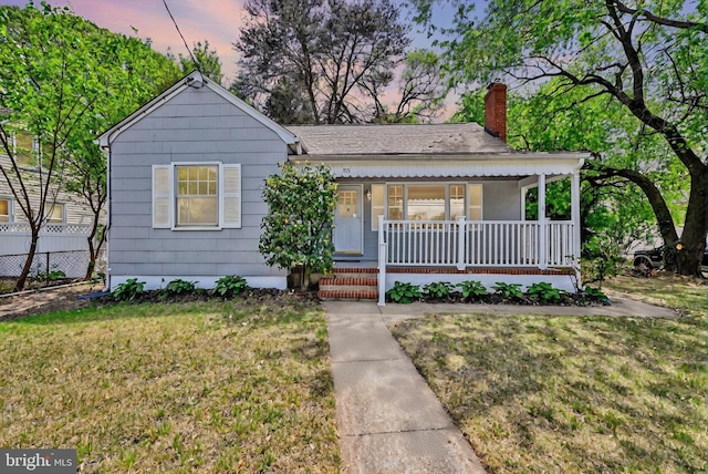 705 Stewart Ave, Glen Burnie, MD 21061 - view of front of house with covered porch and a chimney
