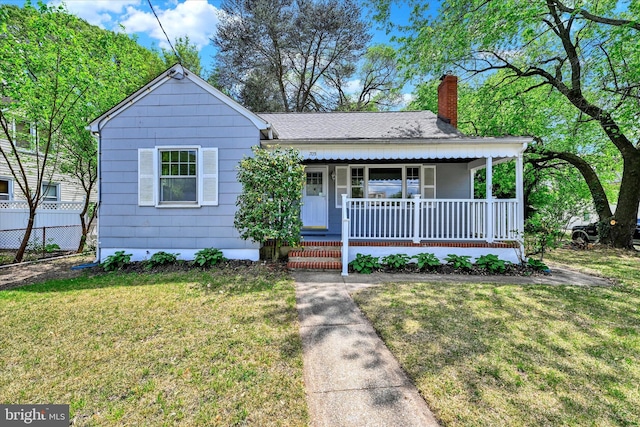 705 Stewart Ave, Glen Burnie, MD 21061 - view of front of house with covered porch, a chimney, and a shingled roof