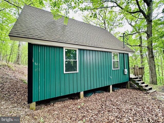 view of property exterior featuring roof with shingles