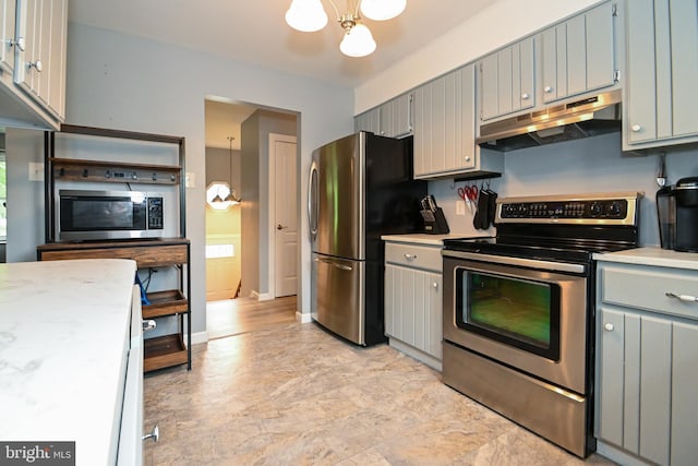 kitchen featuring under cabinet range hood, an inviting chandelier, light countertops, and stainless steel appliances