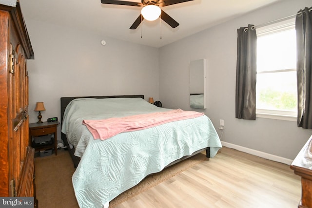 bedroom with baseboards, a ceiling fan, and wood finished floors