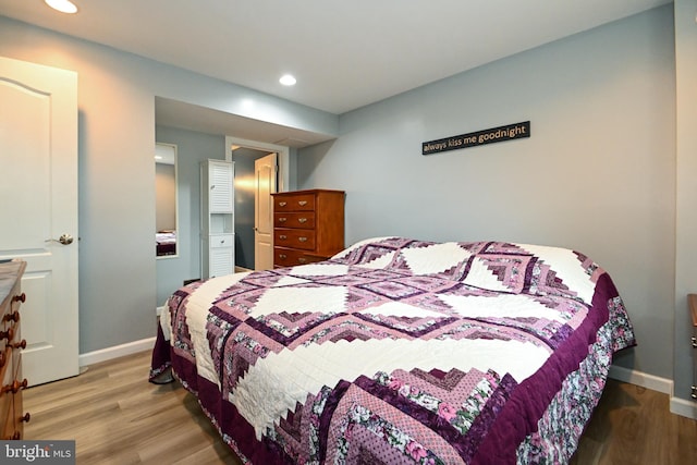 bedroom with recessed lighting, baseboards, and wood finished floors