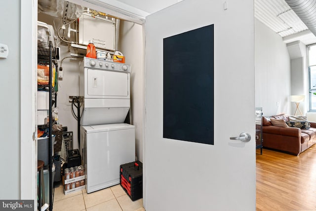 2200 Arch St Unit 409, Philadelphia, PA 19103 - clothes washing area with laundry area, stacked washer and clothes dryer, and tile patterned floors