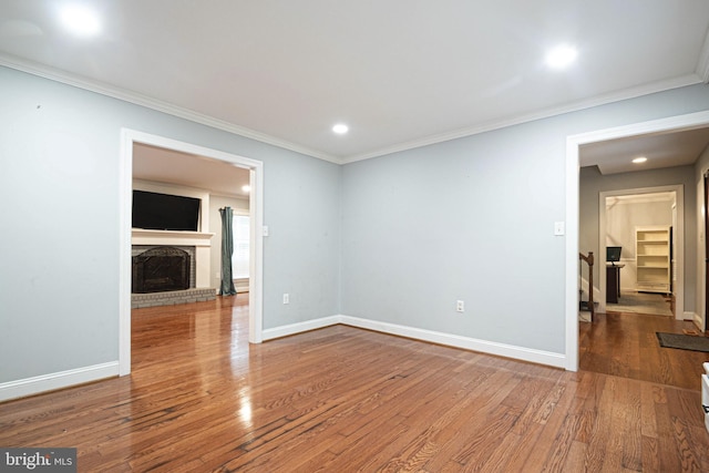 9190 Balsam Run, Bel Alton, MD 20611 - spare room featuring baseboards, a fireplace, crown molding, and wood finished floors
