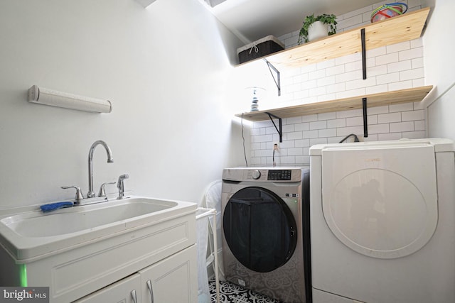 9190 Balsam Run, Bel Alton, MD 20611 - clothes washing area featuring washing machine and dryer, a sink, and cabinet space