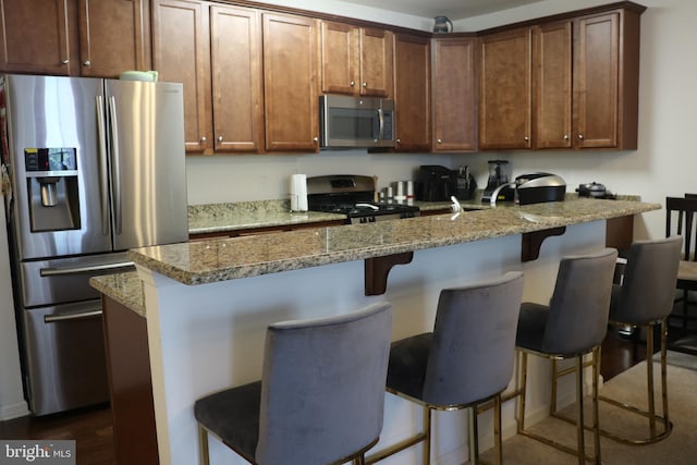 178 Creekside Way, Burlington, NJ 08016 - kitchen featuring a breakfast bar area, appliances with stainless steel finishes, light stone counters, and dark wood finished floors