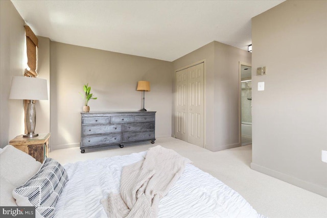bedroom with light carpet, a closet, and baseboards